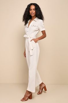 If you want to stay comfortable while looking cute, then the Lulus Practical Perfection Ivory Twill Short Sleeve Jumpsuit was made for you! Slightly stretchy woven twill shapes this trendy jumpsuit that has a collared neckline framed by short cuffed sleeves. Bodice has decorative, twin pocket flaps at the front with a functional button placket. Fitted waist features belt loops, a tying sash belt, and a hidden zip fly, all atop straight pant legs with diagonal side pockets and ankle-length hems. Casual Cotton Jumpsuits And Rompers For Work, Elegant Cotton Jumpsuits And Rompers For Summer, Chic Cotton Jumpsuits And Rompers For Summer, Chic Cotton Summer Jumpsuits And Rompers, Elegant Relaxed Fit Jumpsuit In Solid Color, Chic Cotton Jumpsuits For Work, Spring Cotton Jumpsuits And Rompers For Work, Chic Cotton Jumpsuits And Rompers For Work, Chic Cotton V-neck Jumpsuits And Rompers