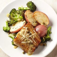 a white plate topped with meat, potatoes and broccoli