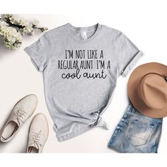 I'm Not Like A Regular Aunt I'm A Cool Aunt Shirt, Best Aunt Shirt, Cool Aunt Shirt, Favorite Aunt Shirt, Gift for Aunt, New Auntie Shirt Black design for Athletic Heather, White, Baby Blue, Pink, Orange, Heather Peach, Yellow, Banana Cream, and Desert Pink. White design for all other colors Premium quality printed in the USA. Free Shipping on orders over $35 (US only) Printed in the USA High quality, durable shirts, sweatshirts, hoodies etc. A B O U T U S We offers custom t-shirts for any occas Casual Gray Tops With Funny Text, Casual Gray Top With Funny Text, Funny Text Print Shirt For Spring, Spring Cotton Shirt With Funny Text, Gray Relaxed Fit Top With Funny Text, Gray Cotton Tops With Funny Print, Funny Spring Shirt With Relaxed Fit, Funny Relaxed Fit Shirt For Spring, Spring Novelty Shirt With Relaxed Fit