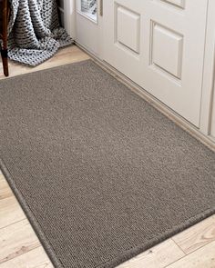 a door mat in front of a white door