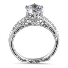 a white gold engagement ring with an oval cut diamond in the center and pave set shoulders