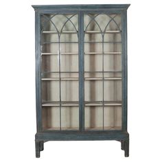 an old blue bookcase with glass doors