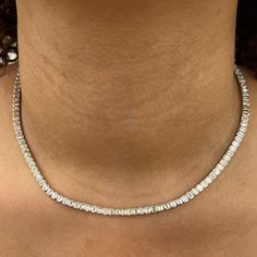 A fresh take on the classic tennis necklace, the 11.5 carat Bezel-Set Emerald Tennis Necklace features bezel-set emerald-cut diamonds set 360° around the neck, allowing diamonds to sparkle from all angles. Designed with comfort in mind, this necklace is handmade to be fluid, not rigid, allowing it movement for comfortable wear. This product has a longer lead time and may take up to 5 weeks for delivery. Luxury Bezel Set Tennis Necklace, Diamond White Cubic Zirconia Tennis Necklace With Baguette Diamonds, Diamond White Baguette Cubic Zirconia Tennis Necklace, Anniversary White Gold Tennis Necklace With Baguette Diamonds, White Gold Tennis Necklace With Baguette Diamonds For Anniversary, Fine Jewelry Diamond Tennis Necklace With Baguette Diamonds, Diamond White Tennis Necklace With Baguette Diamonds, White Gold Diamond Tennis Necklace With Baguette Cut, White Gold Baguette Cut Tennis Necklace For Gift