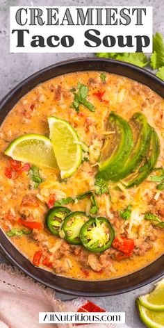 a bowl filled with creamed taco soup and topped with sliced jalapenos