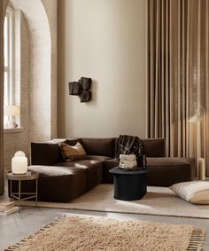 a living room filled with lots of furniture next to a wall mounted clock and window