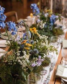 the table is set with blue and yellow flowers