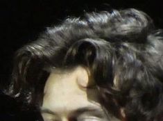 a close up of a person with curly hair