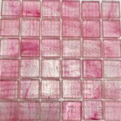 pink glass mosaic tiles on a white surface with red and purple streaks in the middle