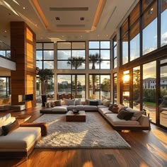 a large living room with lots of windows and couches on top of the floor