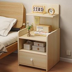 a small wooden shelf next to a bed with a clock on the wall above it