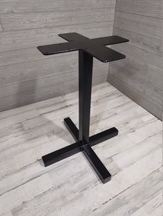 a black table sitting on top of a wooden floor