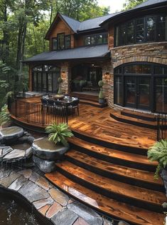 a large wooden deck in front of a house with steps leading up to the patio