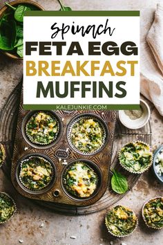 spinach and feta egg breakfast muffins on a tray with green leaves