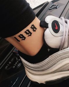 a person with a tattoo on their foot that says air max 95795