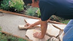 a man sanding on top of a cement slab