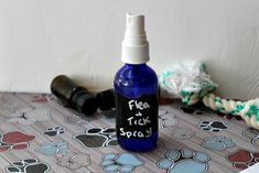 a bottle of flea - tick spray sitting on top of a table with paw prints