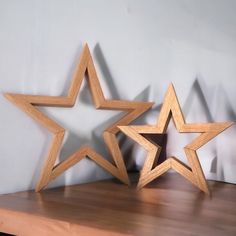 two wooden stars sitting on top of a table