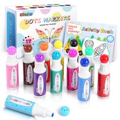 an assortment of colorful markers and pens in front of a box with stickers on it