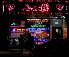 a neon sign is lit up on the side of a building