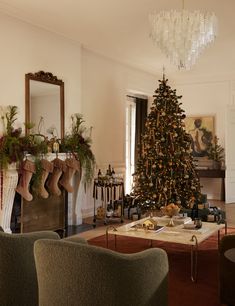 a living room filled with furniture and a christmas tree