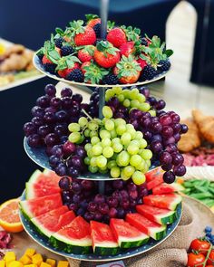 three tiered trays filled with different types of fruit