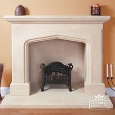 a white fireplace with candles on the mantle