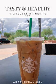 a starbucks drink sitting on top of a table with the words tasty & healthy starbucks drinks to try