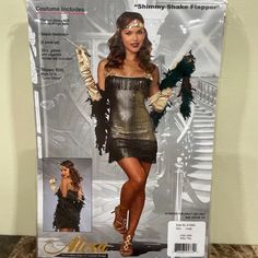 For Sale Is A Brand New Adult Sexy Shimmy Shake Flapper Halloween Costume. This 2 Piece Set Includes Shiny, Metallic Gold Flapper Dress With A Double Fringe Hem, Black Velvet Back, And Gold Bow Details. Gold Sequin Headpiece Also Included. Other Accessories Not Included. Size Large For 140-160 Lbs. It Is In The Original Package And Ready For Halloween. Glamorous Fitted Flapper Dress For Night Out, Fitted Flapper Dress For Club And Party Season, Fitted Gothic Party Costume, Fitted Flapper Dress For Club, Black Flapper Dress For Costume Party, Vintage Black Costume For Costume Party, Vintage Fitted Halloween Costumes, Fitted Vintage Halloween Costumes, Fitted Flapper Dress For Costume Party Gatsby Style