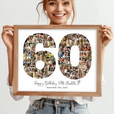 a woman holding up a framed photo with the number sixty