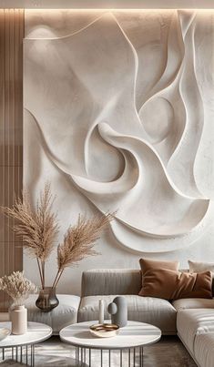 a living room filled with white furniture and walls covered in abstract art work on the wall