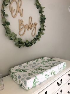 a baby's crib is decorated with greenery