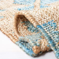 a blue and beige rug on top of a white table