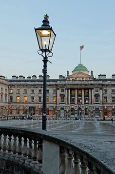 a lamp post in front of a large building