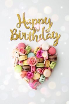 a happy birthday card with macaroons and roses in the shape of a heart