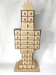 a wooden toy tower with drawers and knobs on each side, made to look like an office cubicle