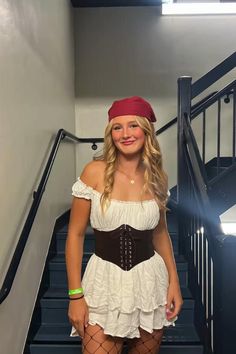 a woman wearing a pirate costume standing in front of stairs with the caption halloween costumes for the girls