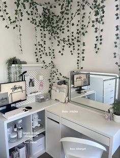 a white desk topped with a computer monitor next to a mirror