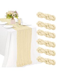 the table is set with white plates and napkins, along with several braided place mats