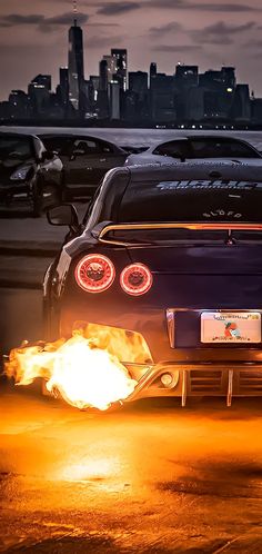 the back end of a sports car with flames coming out of it's exhaust