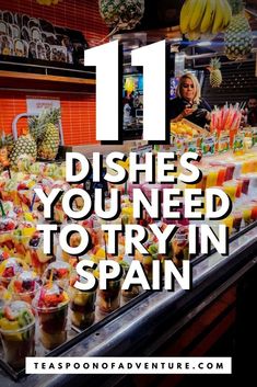 a display case filled with lots of different types of foods and drinks in it, with the words 11 dishes you need to try in spain