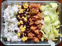 a plastic container filled with rice, beans and lettuce