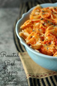 a blue bowl filled with pasta on top of a table