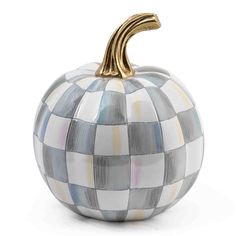 a white and blue checkered pumpkin with a gold handle on it's head