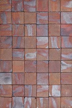 the tile is made up of many different colors and shapes, including dots on them