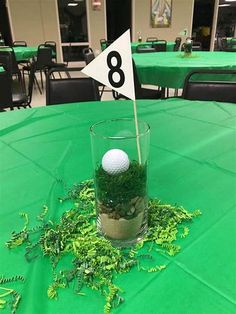 a golf ball in a glass filled with moss