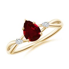 a yellow gold ring with a pear shaped red stone and two diamonds on the side