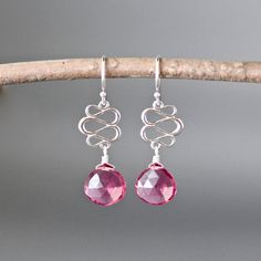 "Bright Hot Pink Quartz faceted teardrop stones are wire wrapped with silver wire onto delicate Bali Silver ribbon links.  These dangle from silver earwires. Choose from balled silver earwires (as shown and sent with stoppers for the ends of the wires) or plain leverback earwires (these close in the back).  The color of these stones is just gorgeous!  Wear them with anything for daytime or evening. Bali Silver link: 10x12mm Hot Pink Quartz stones: 10x10mm Total length of earrings: 1 3/8\" All si Earrings Bali, Hot Pink Earrings, Ribbon Earrings, Bali Silver, Silver Dangle Earrings, Earrings Pink, Pink Gemstones, Quartz Rose, Pink Earrings