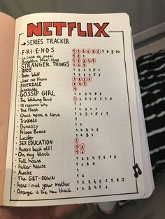 a hand holding up a notebook with the words netflix and other things in red on it