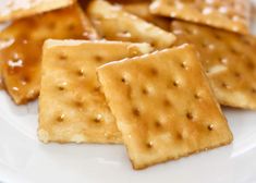 some crackers on a white plate with sauce