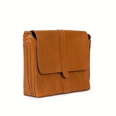 his timeless silhouette was inspired by old leather tool boxes, capturing the spirit of creativity and craftsmanship. Intricate, woven side panel detailing and thoughtful design elements make this satchel a truly unique piece. Handcrafted from medium-structured leather with a beautifully, boxy silhouette, it has ample space and practical pockets to keep you organized with a fully adjustable strap for easy wear. FREE SHIPPING (US Domestic) Handmade in India Materials: full grain leather; hand-blo Timeless Brown Saddle Satchel Bag, Classic Rectangular Flap Bag With Textured Leather, Classic Brown Flap Bag With Textured Leather, Timeless Brown Flap Bag For Everyday Use, Classic Textured Leather Rectangular Flap Bag, Classic Brown Textured Leather Flap Bag, Timeless Rectangular Flap Bag With Leather Lining, Rectangular Leather Saddle Bag For Work, Cognac Textured Leather Satchel For Office